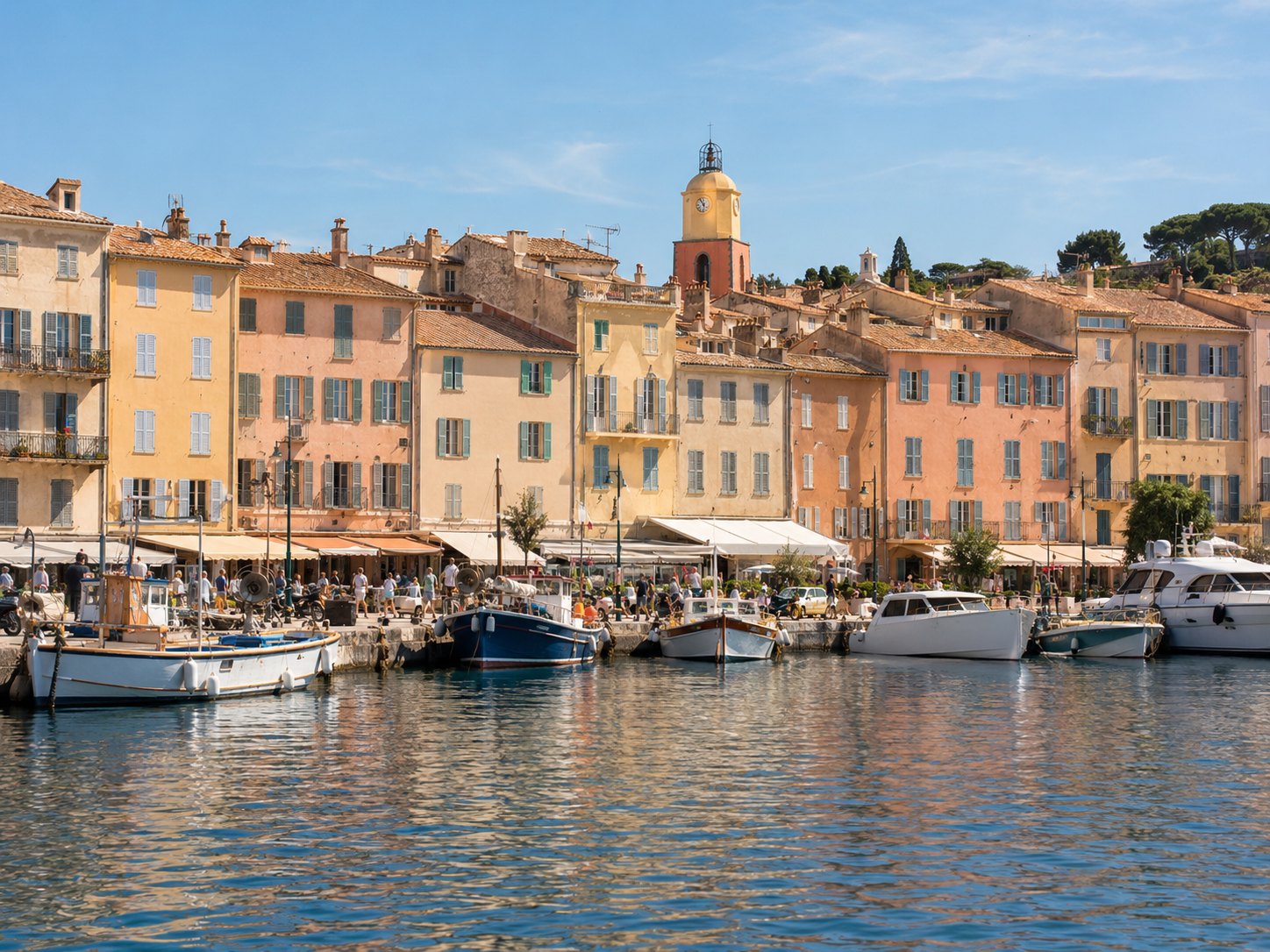 Le port de Saint-Tropez, ses façades colorées et le clocher dominant les toits.